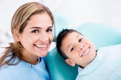 dentist smiling with patient after cosmetic dentistry procedure