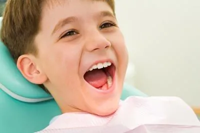 pediatric patient laughing during his dental appointment at The Kid's Place in Boerne, TX