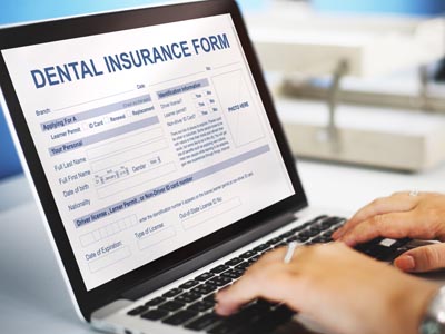 patient filling out a dental insurance form