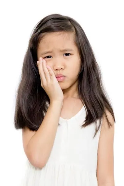 young girl holding her mouth due to tooth pain