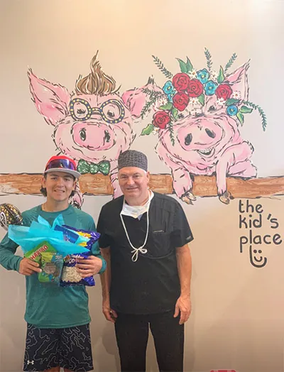 Dr. Wilkerson of The Kid's Place smiling with one of his patients