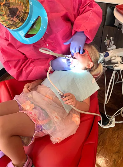 Dr. Wilkerson cleaning a patient's teeth at The Kid's Place in Boerne, TX